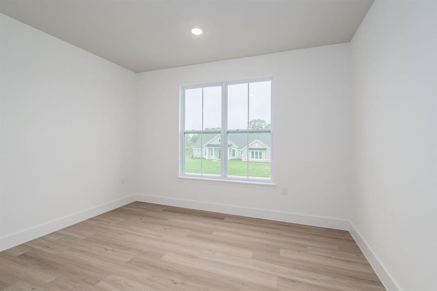 Unfurnished room featuring light wood-type flooring