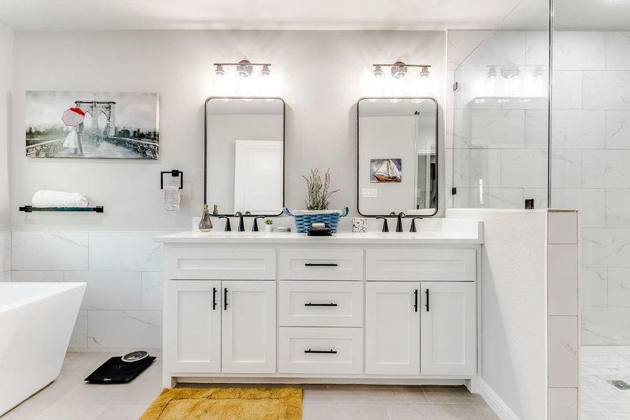 Bathroom with shower with separate bathtub, vanity, tile patterned floors, and tile walls