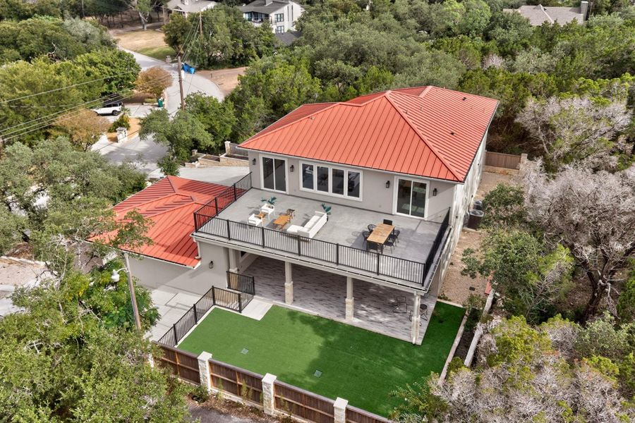 A striking metal roof and expansive upper deck crown this modern hillside residence.