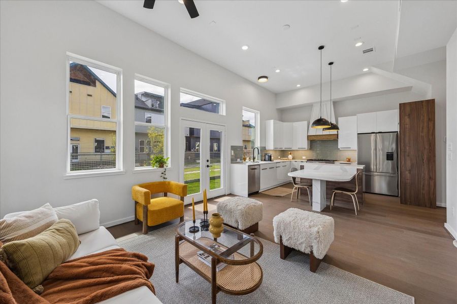 Expansive great room seamlessly blending the living, dining, and kitchen spaces beneath soaring ceilings and abundant natural light. Expansive great room seamlessly blending the living, dining, and kitchen spaces beneath soaring ceilings and abundant natural light.