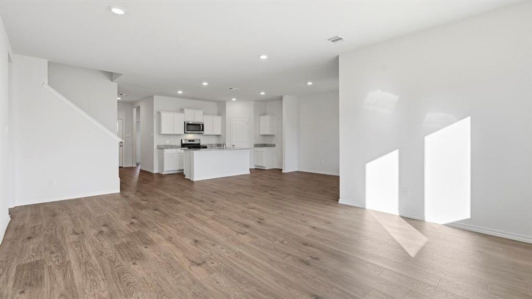 Unfurnished living room with recessed lighting and light wood-style flooring