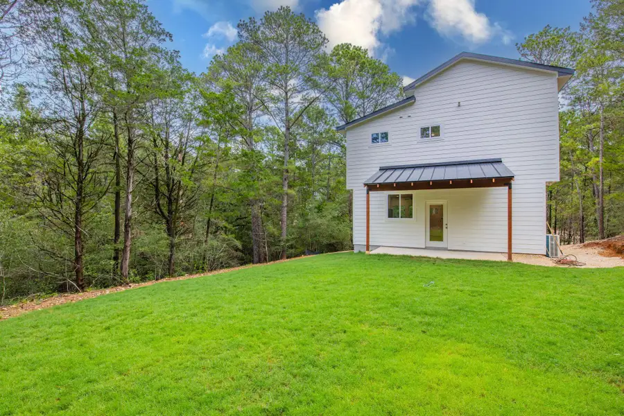 A private yard with new sod and a covered patio offers outdoor serenity. A private yard with new sod and a covered patio offers outdoor serenity.