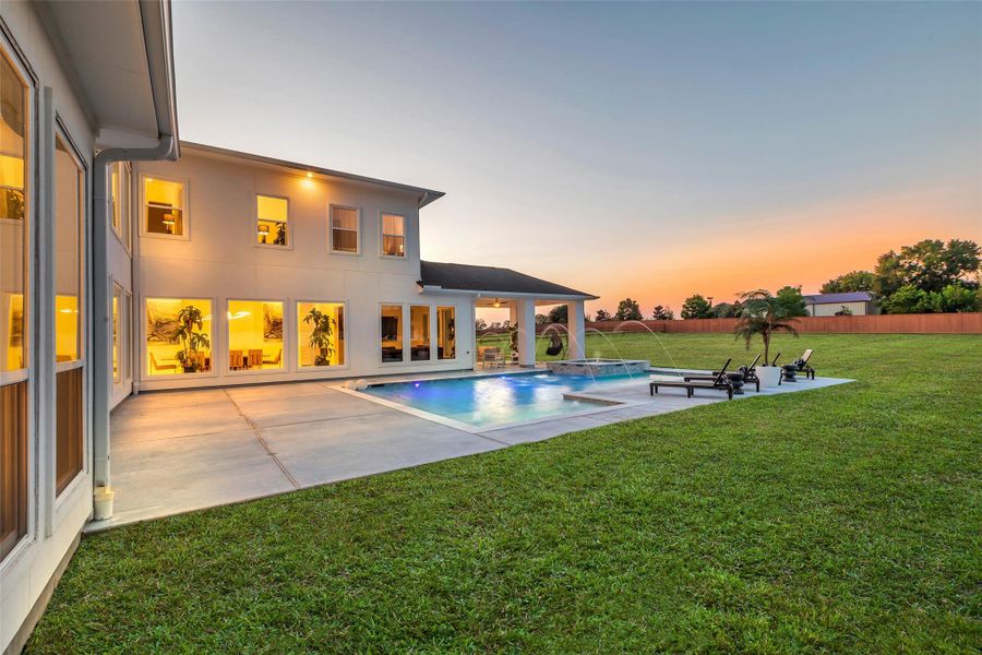 Private outdoor retreat with sparkling heated pool, spa, and a covered patio designed for year-round enjoyment.