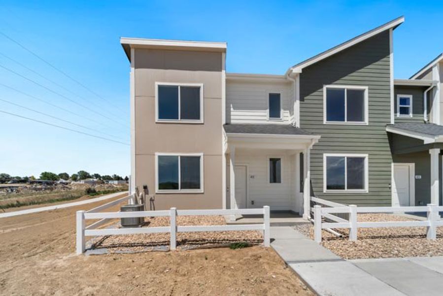 Front exterior of a new home in Liberty Draw, Evans, CO, highlighting curb appeal (Image 1). Front exterior of a new home in Liberty Draw, Evans, CO, highlighting curb appeal (Image 1).