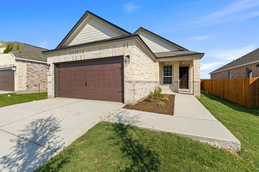 Front exterior of a new home in Salerno - Heritage Collection, Round Rock, TX, highlighting curb appeal (Image 18). Front exterior of a new home in Salerno - Heritage Collection, Round Rock, TX, highlighting curb appeal (Image 18).