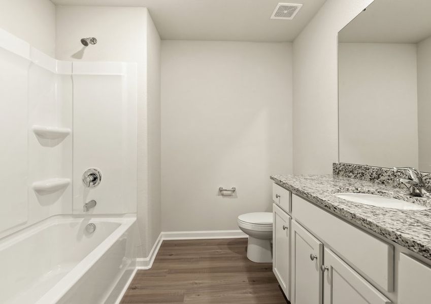 This bathroom has granite countertops and a large soaking tub.