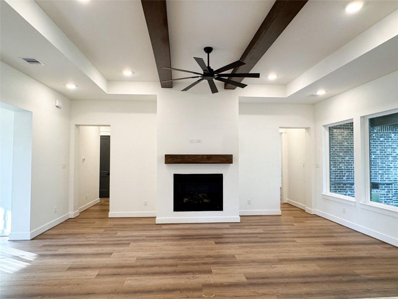 Living Room Showcases Tray Ceiling,  Wood Beams and, Custom Mantle