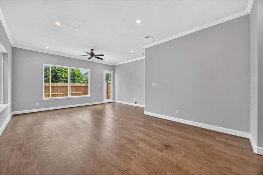 Effortless Flow – Dining space up front leads straight into the living area, where a row of windows overlooking the backyard fills the whole space with natural light.