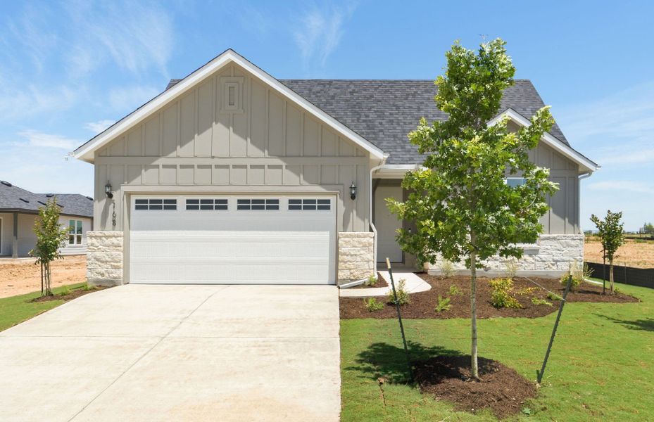 Front exterior of a new home in Del Webb Austin at Lost Pines, Bastrop, TX, highlighting curb appeal (Image 20). Front exterior of a new home in Del Webb Austin at Lost Pines, Bastrop, TX, highlighting curb appeal (Image 20).