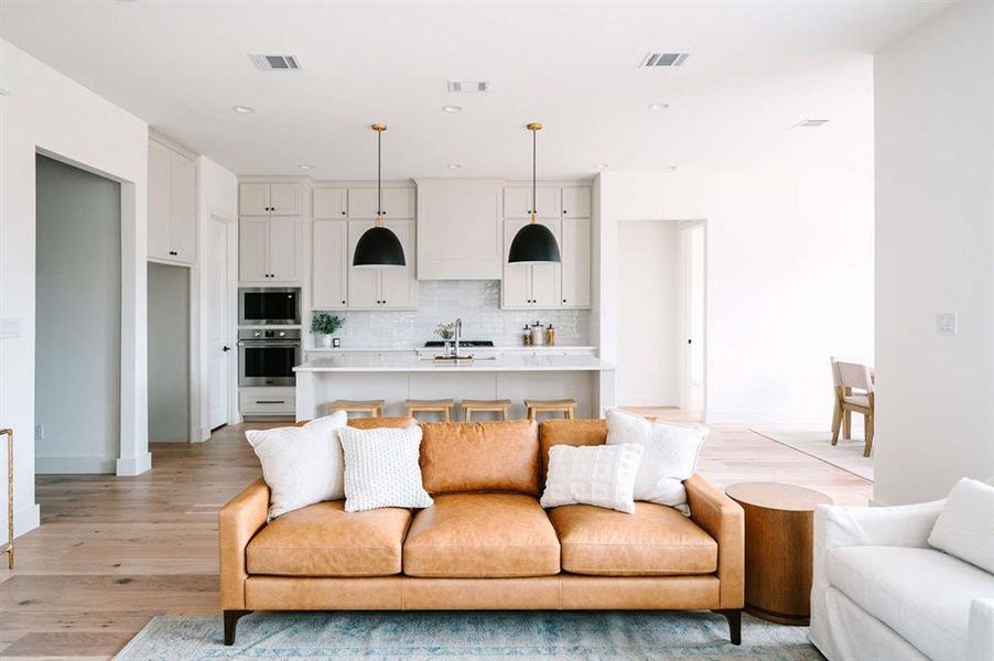 Living room featuring sink and light wood-type flooring