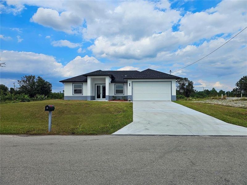 Front exterior of a new home in , Lehigh Acres, FL, highlighting curb appeal (Image 2).