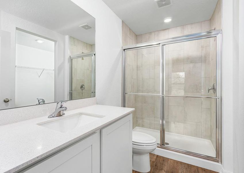 The master bathroom has a walk-in shower with sliding doors.