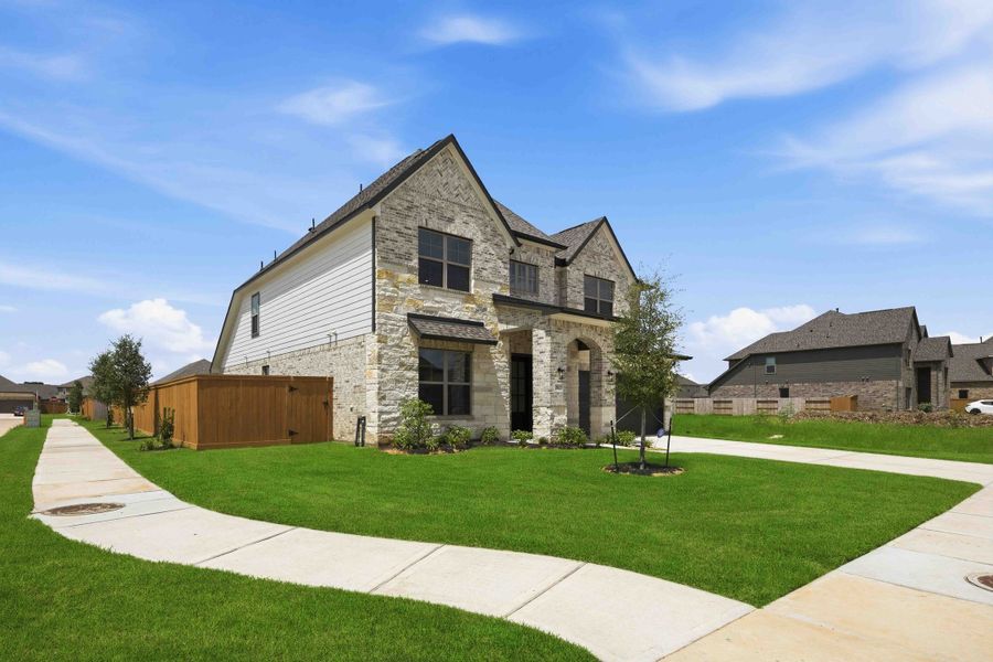 Front exterior of a new home in Sunterra 50s, Katy, TX, highlighting curb appeal (Image 24).