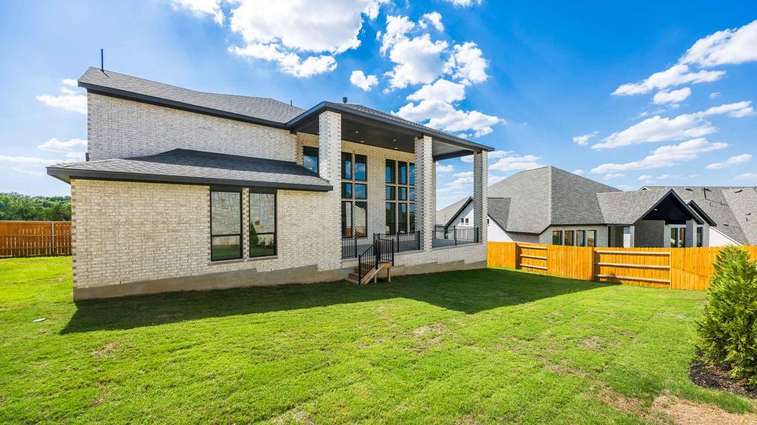 Rear view of house featuring a fenced backyard, brick siding, and a patio Rear view of house featuring a fenced backyard, brick siding, and a patio