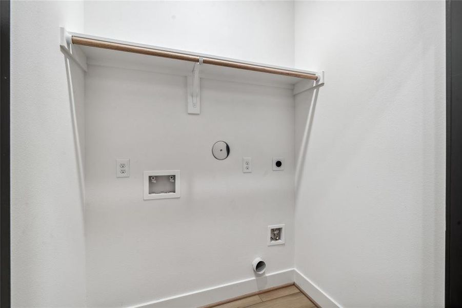 With a practical storage shelf, this utility closet offers a neat, functional space for storing cleaning supplies, linens, or other household items