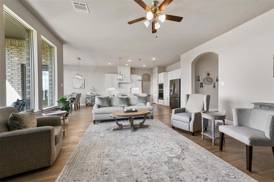 Living room with hardwood / wood-style flooring and ceiling fan