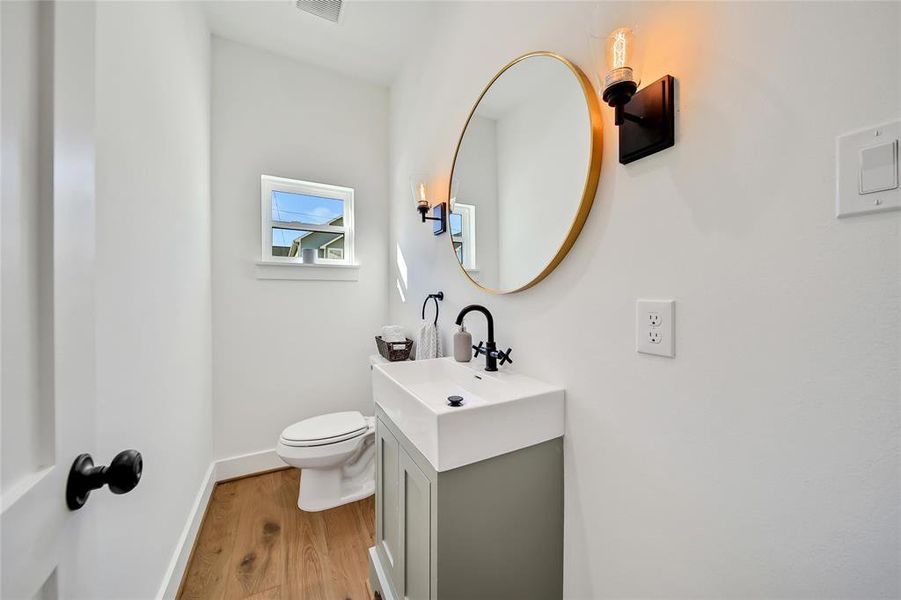 This photo was taken in another staged property with the same finishes and layout. Half Bath on first floor.