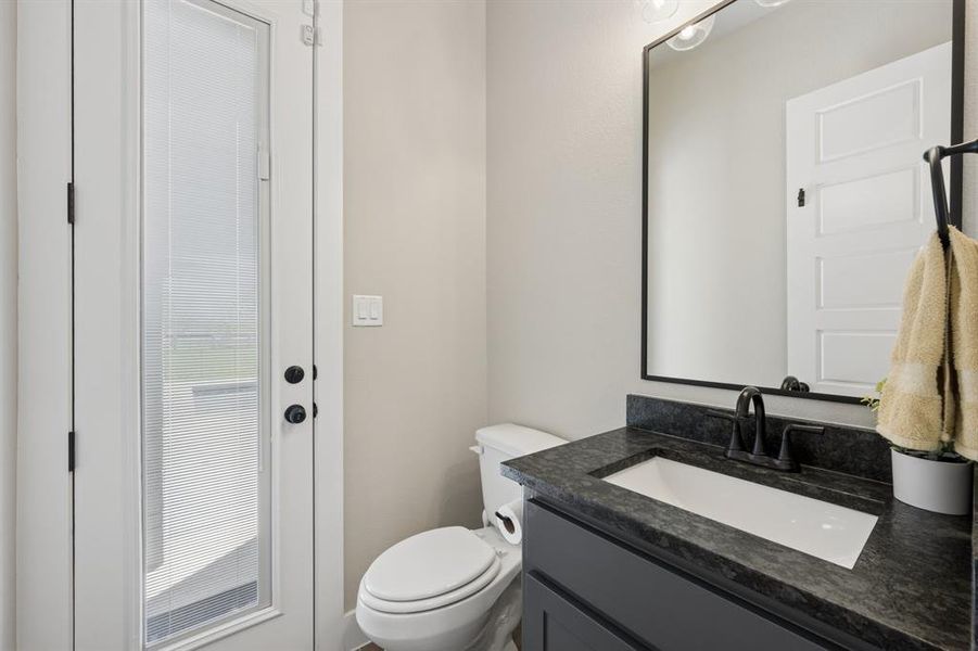 Bathroom featuring vanity and toilet