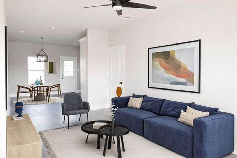 Living room with ceiling fan and hardwood / wood-style floors