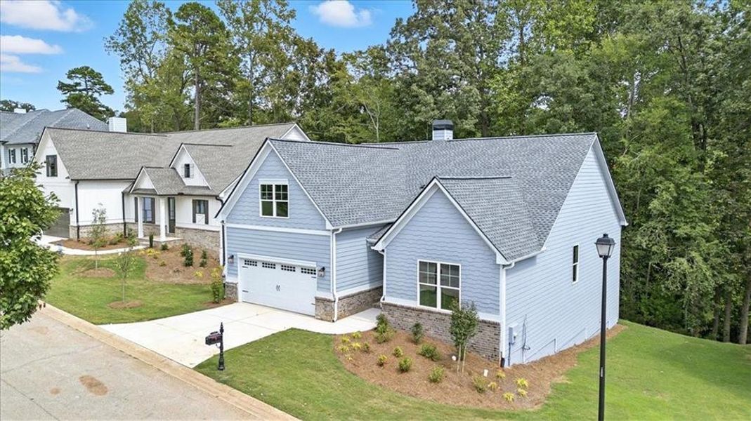 Front exterior of a new home in Traditions of Braselton, Jefferson, GA, highlighting curb appeal (Image 1).