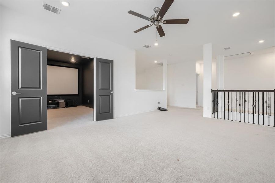 Empty room with light carpet, a ceiling fan, and recessed lighting Empty room with light carpet, a ceiling fan, and recessed lighting