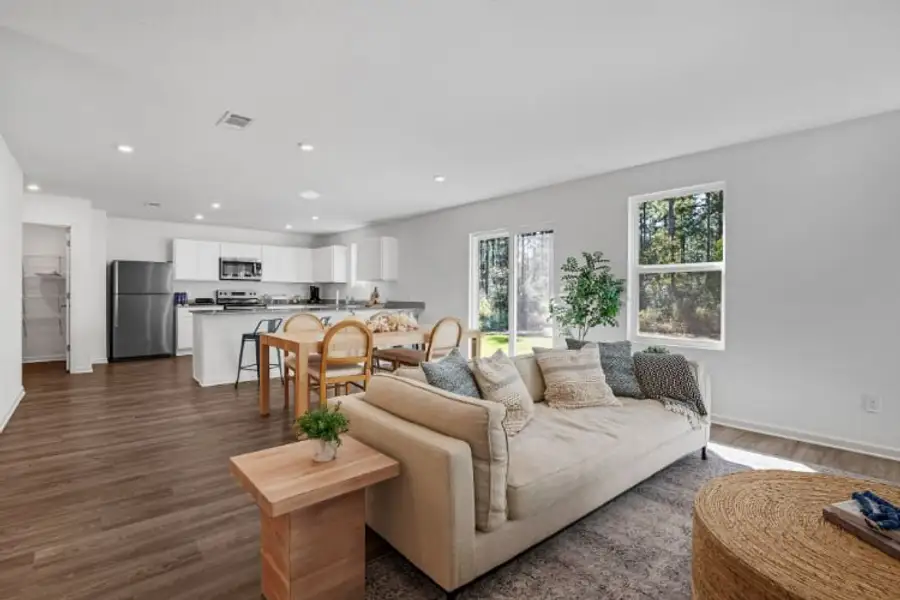 A living room with a couch and a table. A living room with a couch and a table.