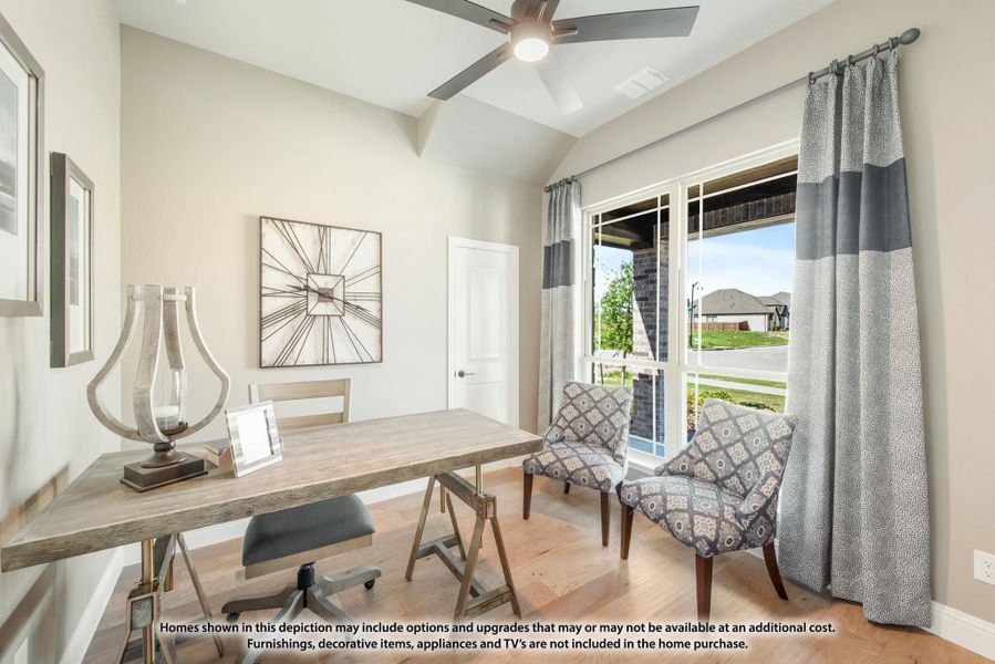 Home office with wood desk, vaulted ceiling, ceiling fan, and large window with patio view Home office with wood desk, vaulted ceiling, ceiling fan, and large window with patio view