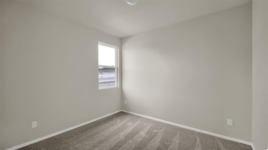 Unfurnished room with light carpet and baseboards