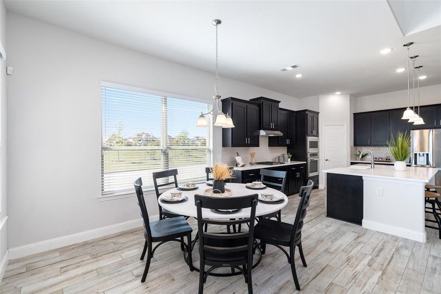 Dining area featuring sink and light hardwood / wood-style flooring