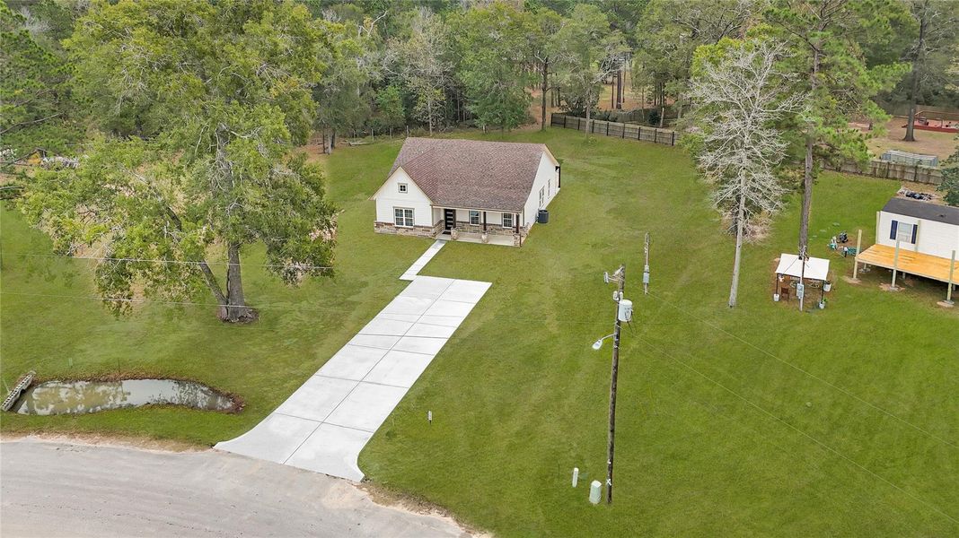 Charming single-story home with a spacious front yard, surrounded by lush trees. Features a long driveway, a small pond, and a quiet, rural setting. Ideal for those seeking a peaceful lifestyle with plenty of outdoor space. Charming single-story home with a spacious front yard, surrounded by lush trees. Features a long driveway, a small pond, and a quiet, rural setting. Ideal for those seeking a peaceful lifestyle with plenty of outdoor space.