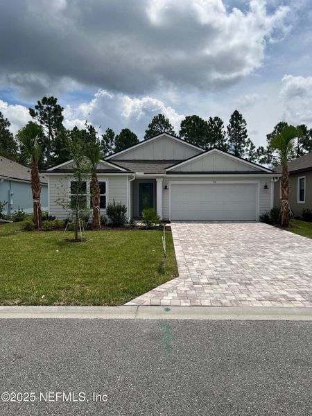 Front exterior of a new home in American Village, Palm Coast, FL, highlighting curb appeal (Image 20).