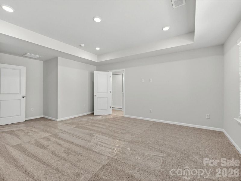 Owners bedroom features tray ceiling