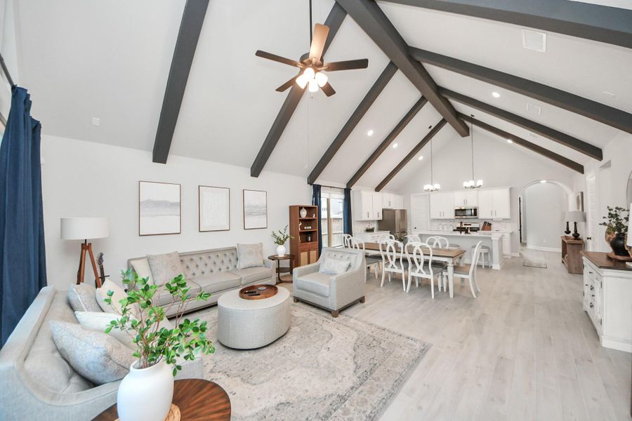 Open-concept layout with seamless flow from family room to dining and kitchen.