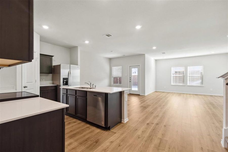 Open-concept living area with wood-finish flooring
