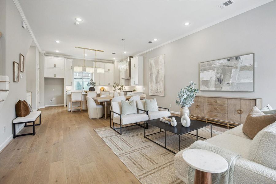 Living room flows seamlessly into dining area and kitchen.
