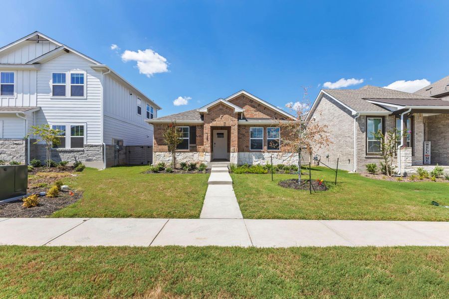 Front exterior of a new home in Flora, Hutto, TX, highlighting curb appeal (Image 17). Front exterior of a new home in Flora, Hutto, TX, highlighting curb appeal (Image 17).
