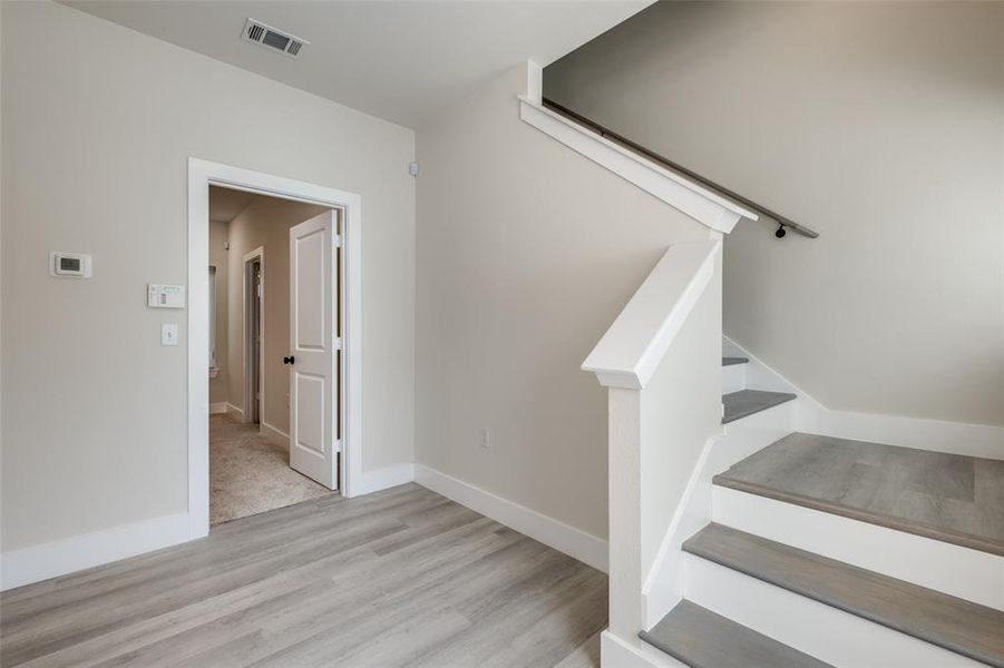 Stairs featuring wood finished floors and baseboards Stairs featuring wood finished floors and baseboards