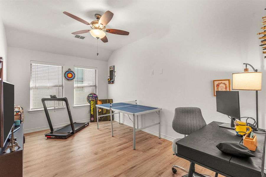 Extra Room with ceiling fan, lofted ceiling, and light hardwood / wood-style flooring