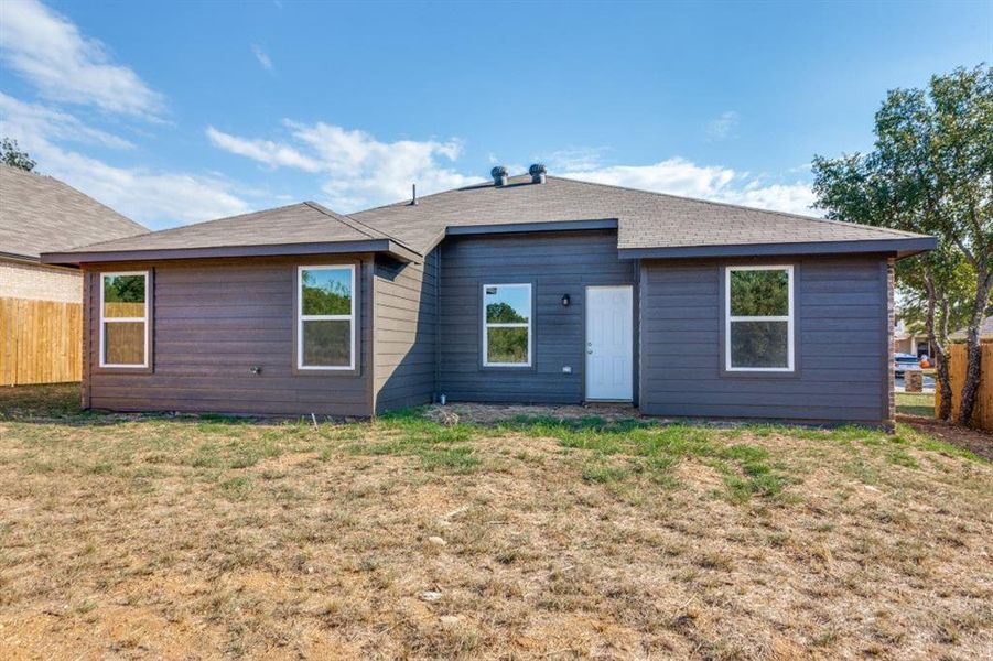 Rear view of house with roof with shingles