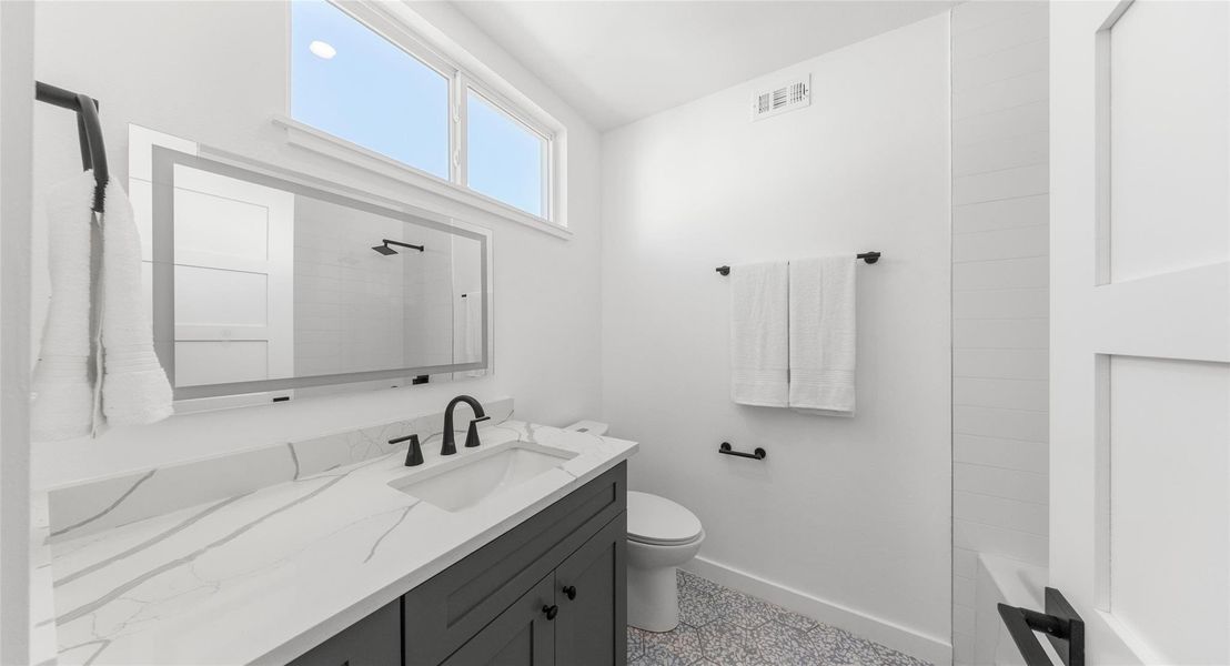 A vaulted-ceiling bath that feels airy and elevated, finished with clean, modern details. Model No. 105 Shown.