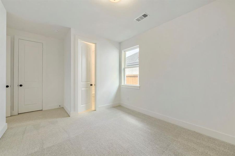 Neutral-toned wall-to-wall carpeting complements bright white walls Neutral-toned wall-to-wall carpeting complements bright white walls