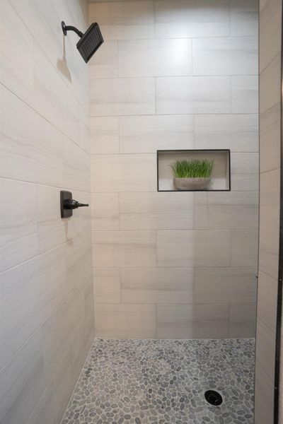 Bathroom featuring a tile shower Bathroom featuring a tile shower