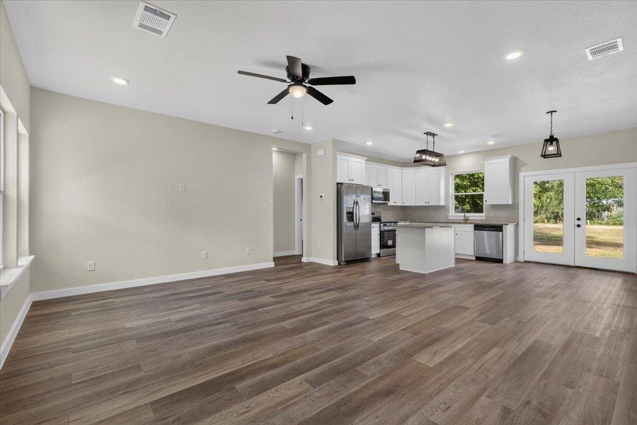An open floor plan connects the main living space seamlessly to a modern kitchen. An open floor plan connects the main living space seamlessly to a modern kitchen.