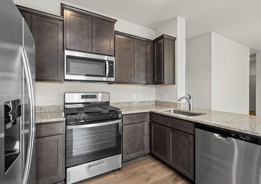The kitchen has stainless steel appliances.