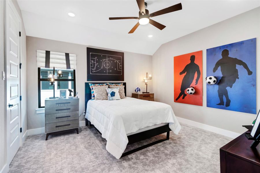 Carpeted bedroom with lofted ceiling, recessed lighting, and a ceiling fan Carpeted bedroom with lofted ceiling, recessed lighting, and a ceiling fan