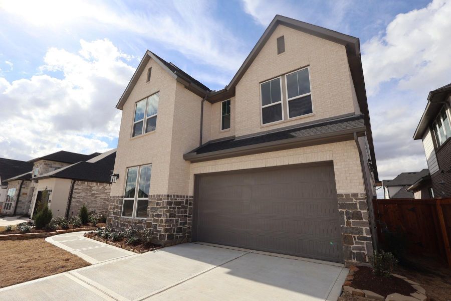 Front exterior of a new home in Dunham Pointe, Cypress, TX, highlighting curb appeal (Image 2). Front exterior of a new home in Dunham Pointe, Cypress, TX, highlighting curb appeal (Image 2).