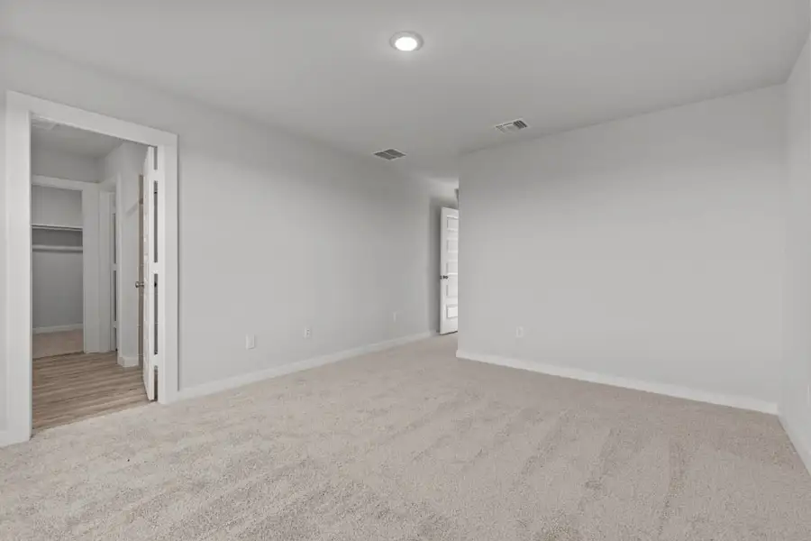 A room with a carpet and a door. A room with a carpet and a door.