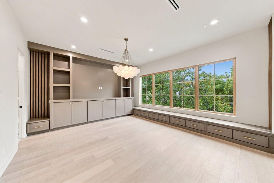 Beautifully crafted - an expansive game room provide thoughtful storage options and reading nooks with a view to nearby Weir Park.