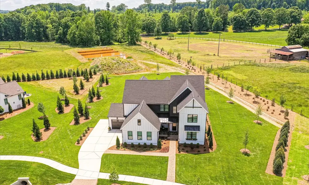 Front exterior of a new home in Stephens Farm, Huntersville, NC, highlighting curb appeal (Image 2). Front exterior of a new home in Stephens Farm, Huntersville, NC, highlighting curb appeal (Image 2).