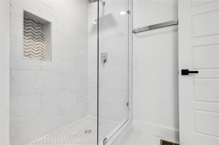 Bathroom featuring walk in shower and tile floors